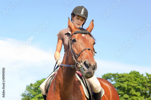 Teenage girl equestrian riding horseback. Vibrant summertime out © AnnaElizabeth
