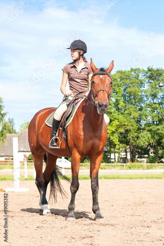 Teenage girl equestrian riding thoroughbred horseback. Vibrant s © AnnaElizabeth