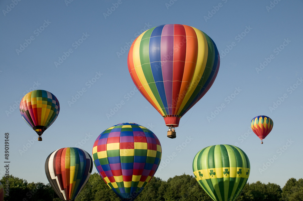 Naklejka premium Hot-air balloons ascending or launching at a ballooning festival