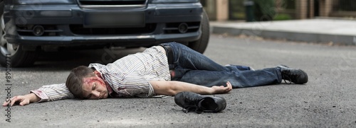 Man lying on street photo