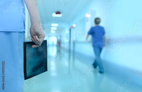 Doctor with x-ray picture in the hospital corridor