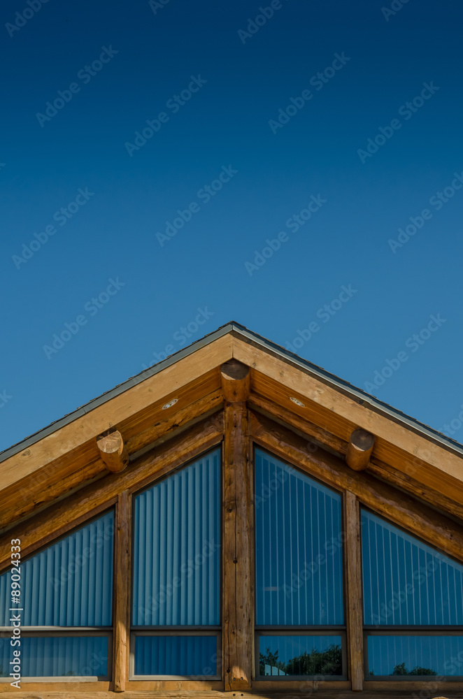 Roof of Log Cabin on Blue Sky