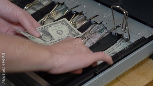 Close up footage of cashier giving change after purchase