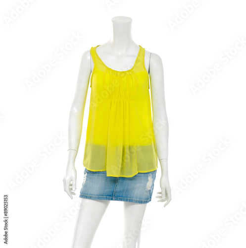 female mannequin in jeans pants with yellow peignoir clothes 