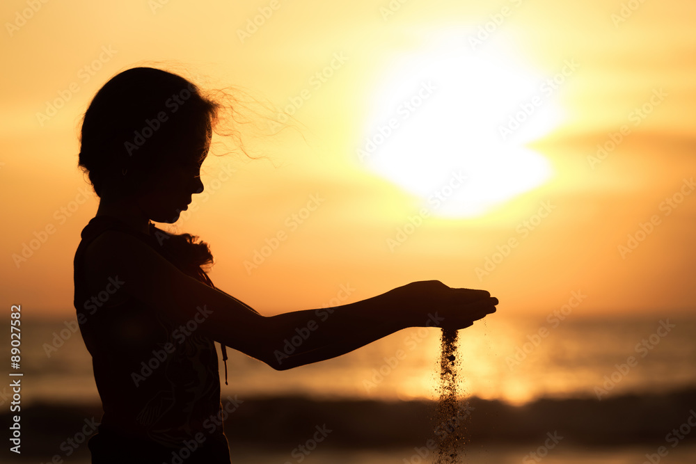 Portrait of sad  little girl standing on the beach