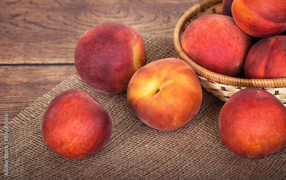 Fresh peach fruits against rustic background Fresh peach fruits against rustic background