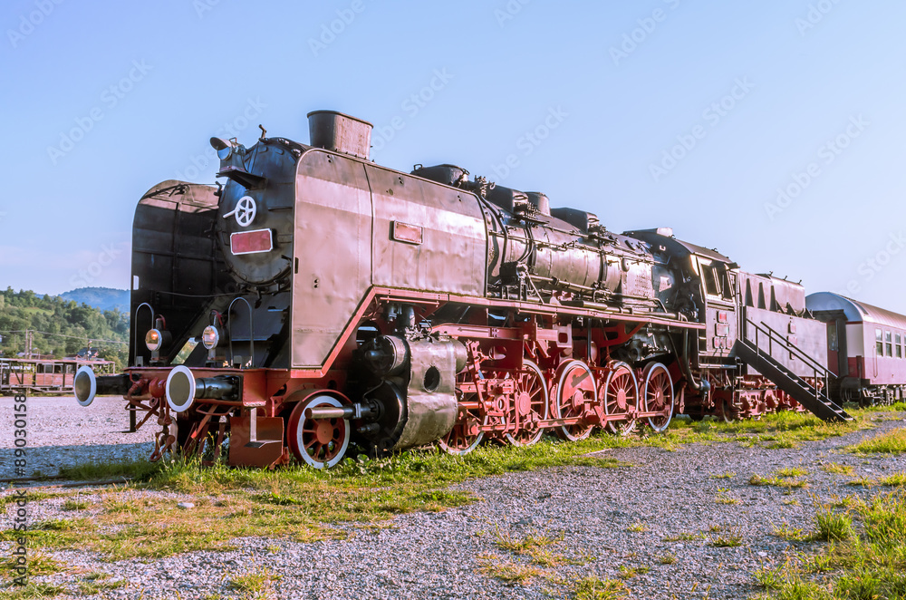 Old black steam powered railway train. Restored old vintage steam train built at Resita, Romania.