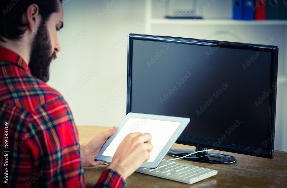 Hipster businessman working on his tablet pc Hipster businessman working on his tablet pc