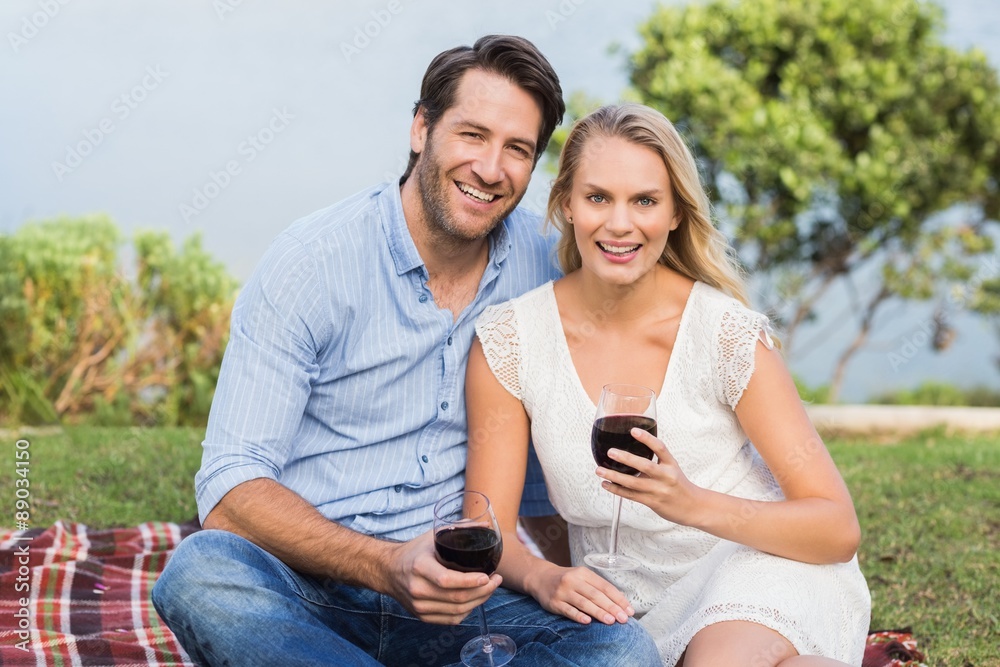 Cute couple on date holding red wine glasses Cute couple on date holding red wine glasses