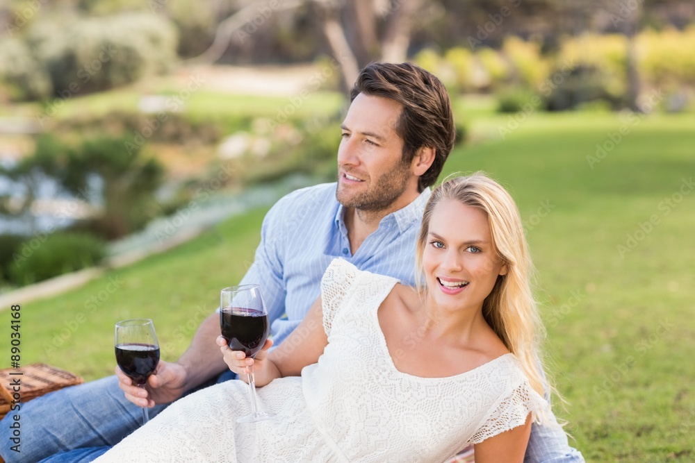 Cute couple on date holding red wine glasses Cute couple on date holding red wine glasses