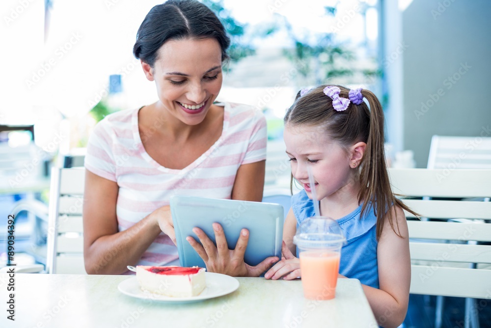 Mother and daughter using tablet computer together Mother and daughter using tablet computer together