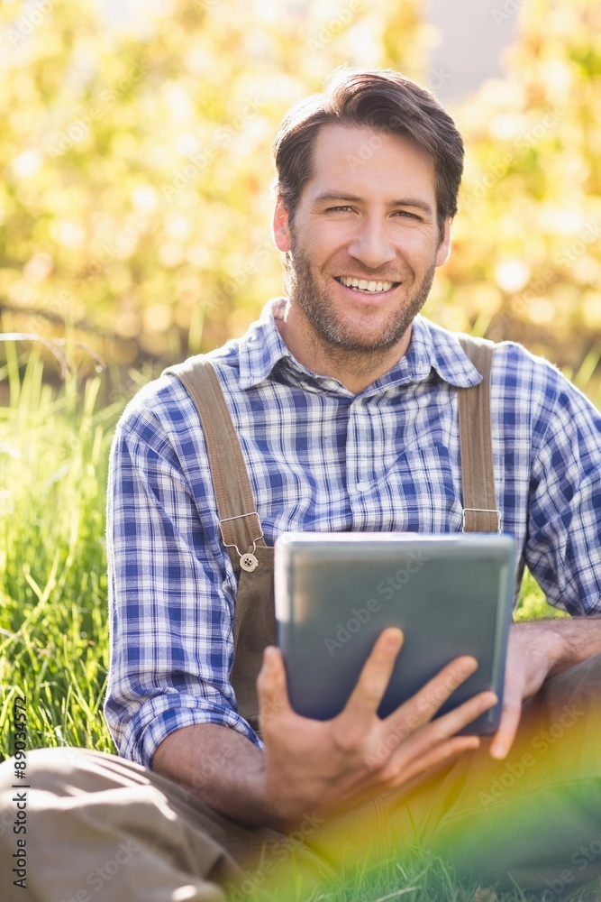 Smiling farmer using a digital tablet Smiling farmer using a digital tablet