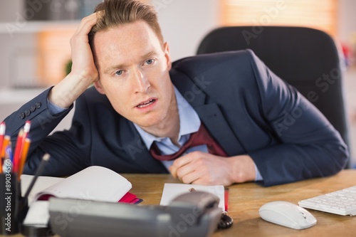Exhausted businessman working at his desk