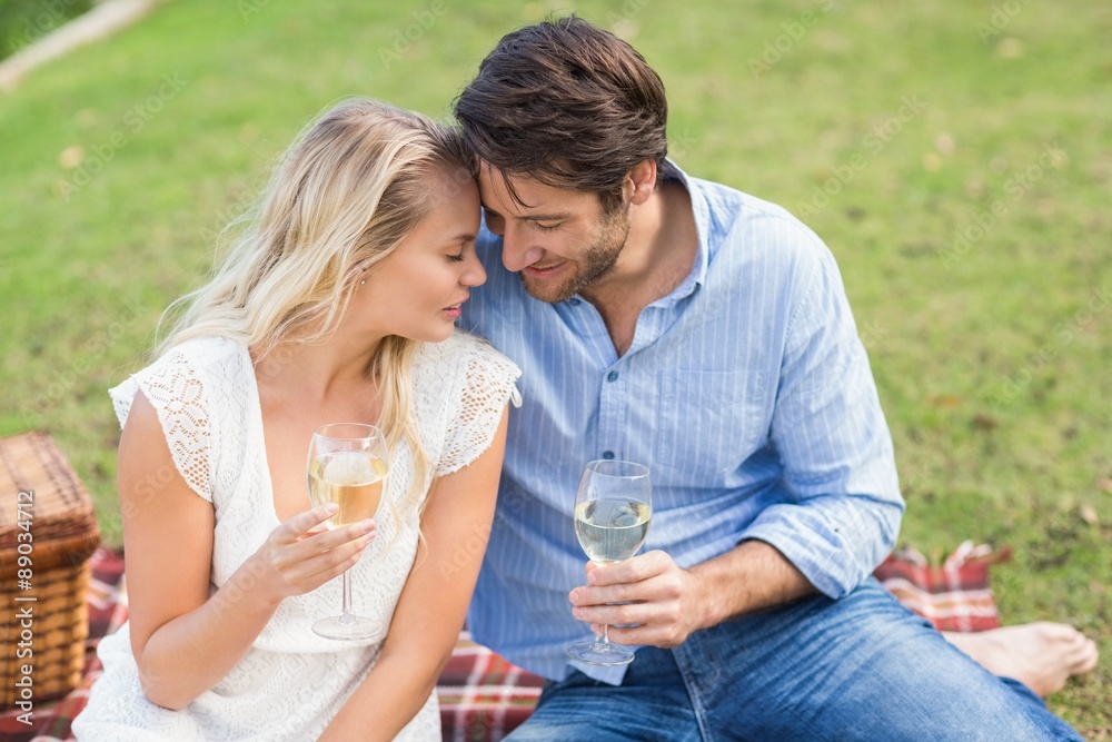 Couple on date holding white wine glasses Couple on date holding white wine glasses