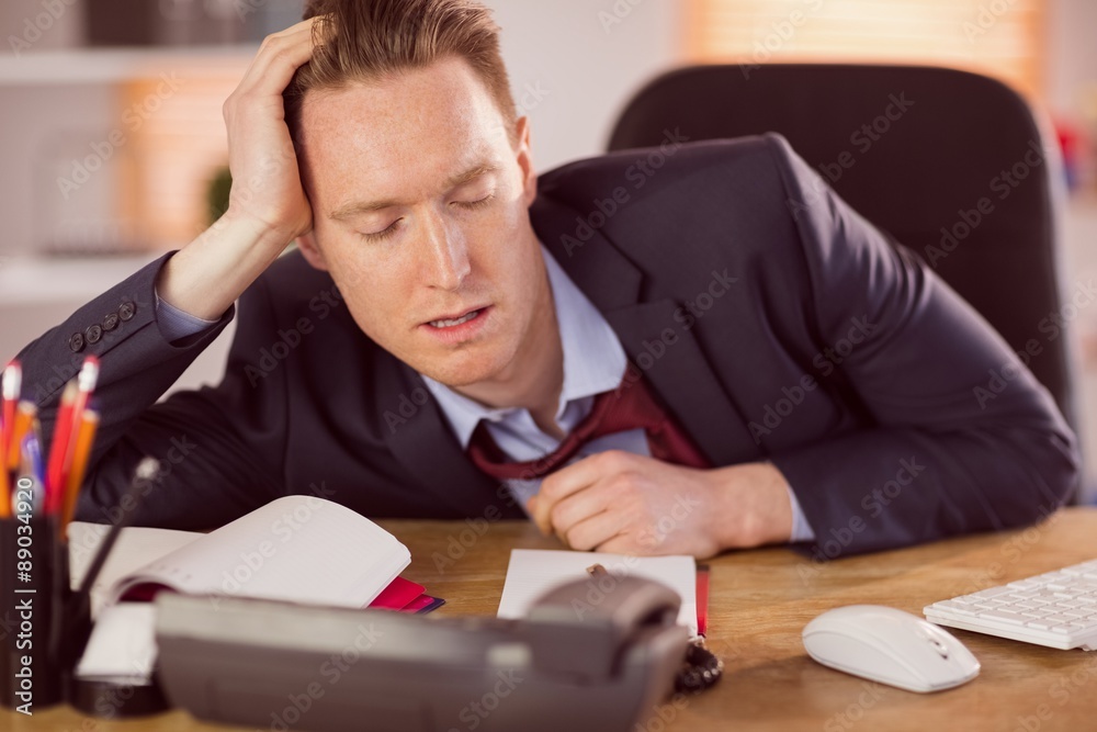 Exhausted businessman sleeping at his desk Exhausted businessman sleeping at his desk