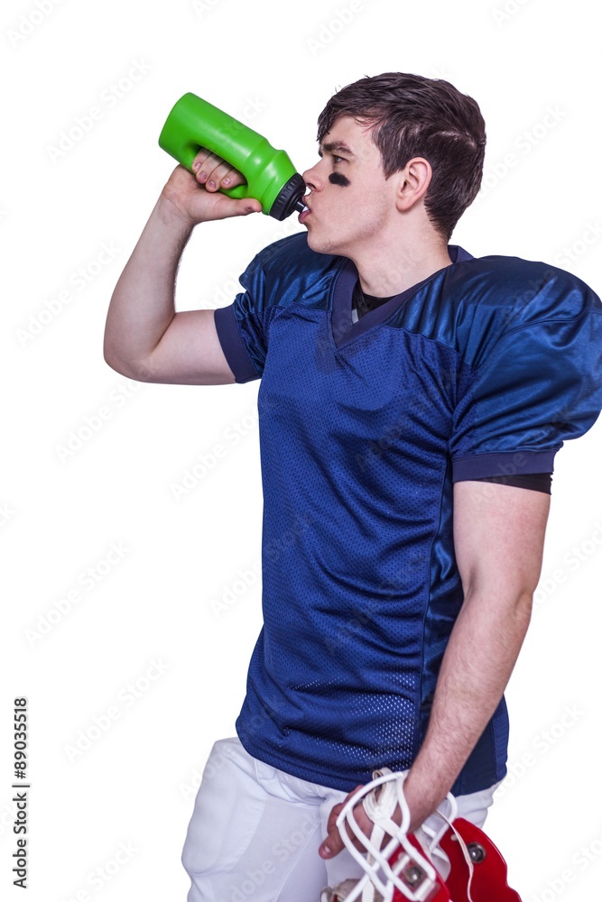 American football player drinking water American football player drinking water