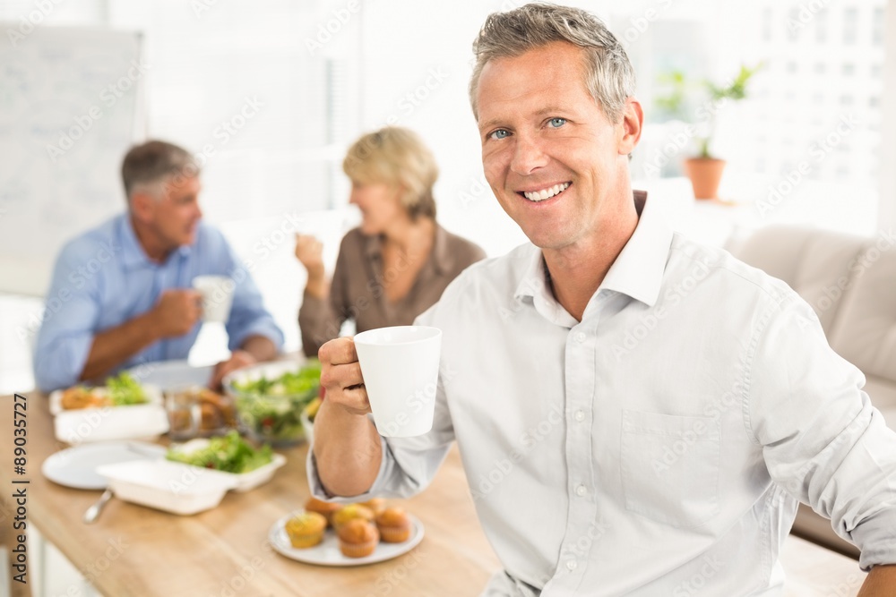 Smiling casual businessman with cup of coffee Smiling casual businessman with cup of coffee