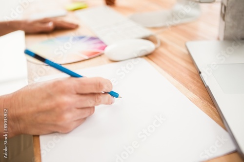 Close up view of hands designing with colour chart 