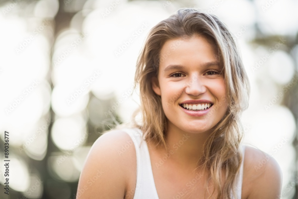 Pretty young jogger smiling at the camera Pretty young jogger smiling at the camera