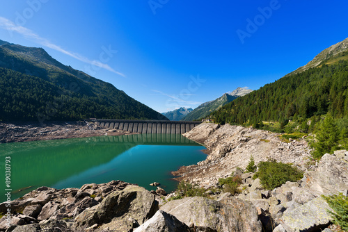 Bissina Lake with Dam - Adamello Trento Italy. Bissina Dam (1952-1962). Straight concrete dam (563 m of length) in the National Park of Adamello Brenta. Trentino Alto Adige, Italy