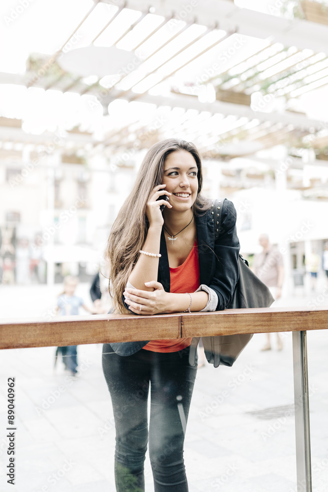 Fototapeta premium Portrait of a beautiful young businesswoman standing outside usi