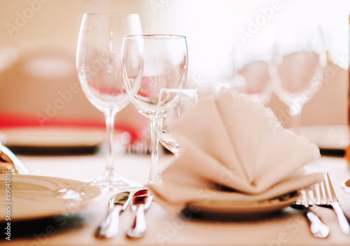 Wedding table. Close-up of folded napkin and empty glasses