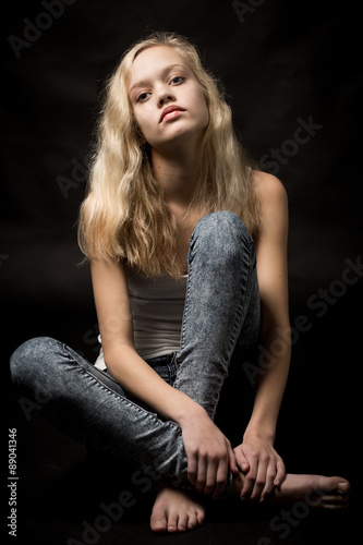 Blond Teenage Girl Sitting On The Studio Floor