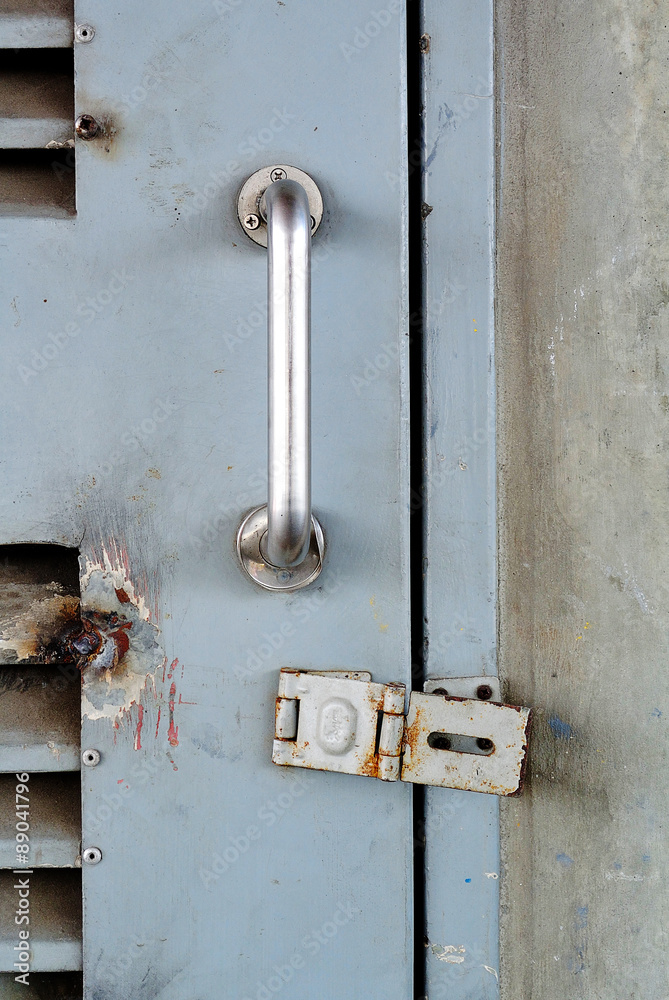 Closeup metal door with lock in grungy style and good texture. Closeup metal door with lock in grungy style and good texture.