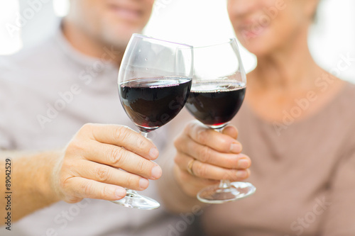 close up of happy senior couple with red wine