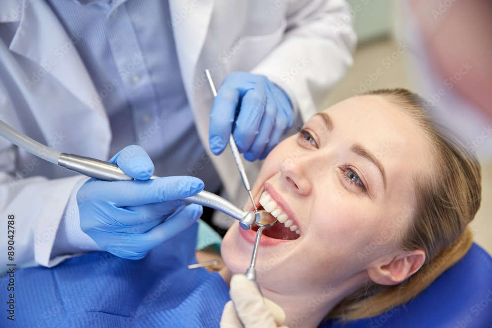 close up of dentist treating female patient teeth close up of dentist treating female patient teeth