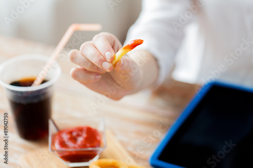 close up of woman hand holding french fries