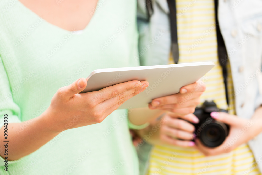 close up of women with tablet pc and camera