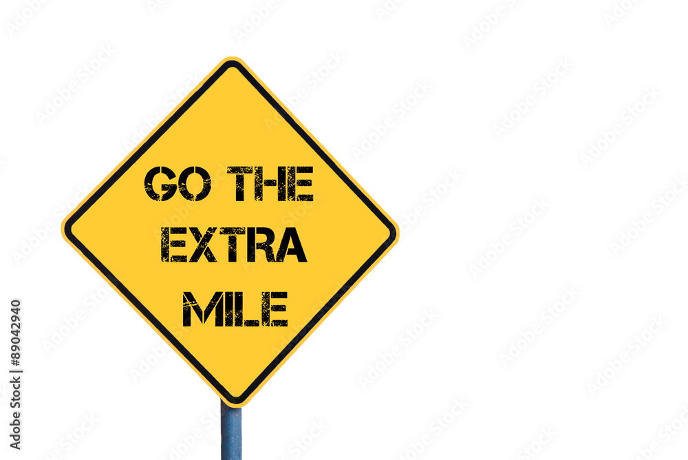 Yellow roadsign with Go The Extra Mile message Yellow roadsign with Go The Extra Mile message