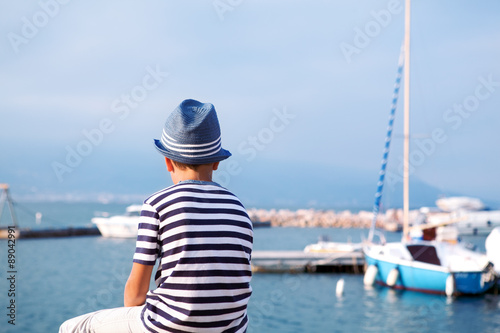 child in hat looking at sea and ship © rimmdream
