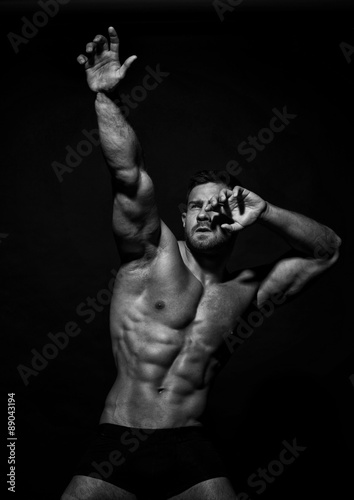 Muscled male model in studio photo