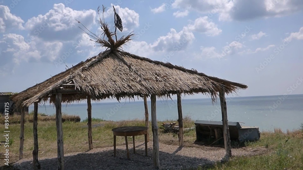 Summer gazebo with a thatched roof, on the sea precipice Summer gazebo with a thatched roof, on the sea precipice
