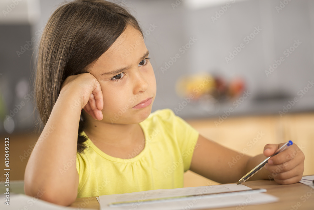 Portrait of little girl doing homework ar table Portrait of little girl doing homework ar table