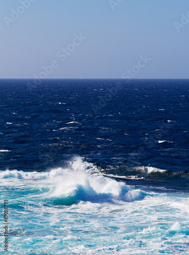 Ocean waves and surf in sunlight