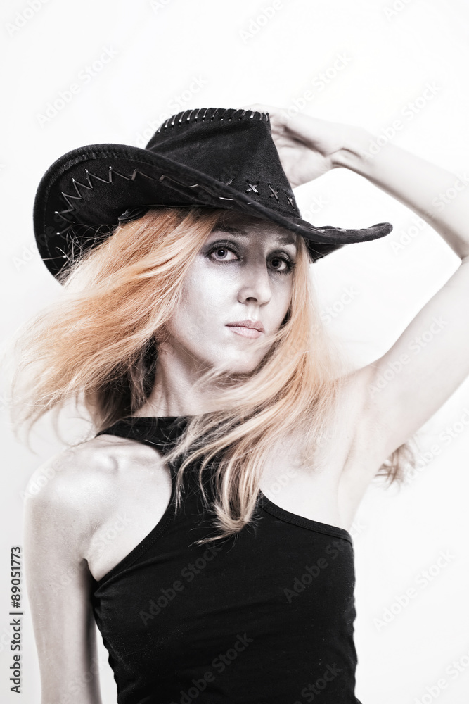 Young beautiful woman with silver make-up in a cowboy hat Young beautiful woman with silver make-up in a cowboy hat