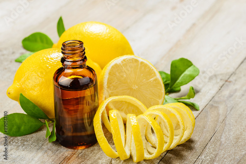 lemon essential oil and lemon fruit on the wooden board, (taken with tilt shift lens)
