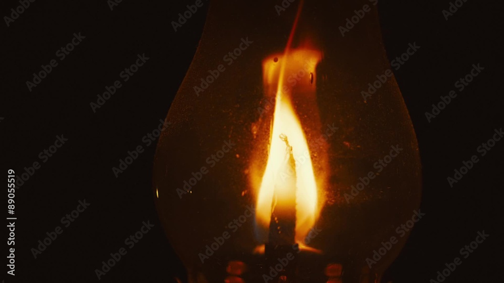A flickering traditional oil lantern against a solid black background with audio
