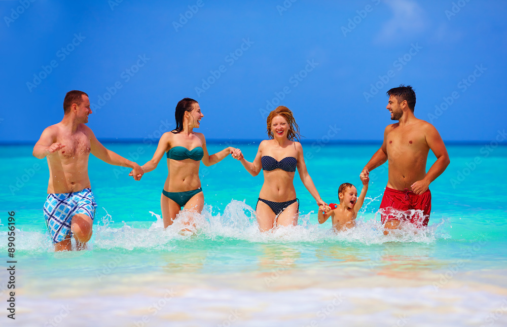 group of joyful friends having fun together on tropical beach group of joyful friends having fun together on tropical beach