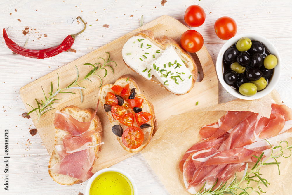 Bruschetta with cheese, tomatoes and prosciutto Bruschetta with cheese, tomatoes and prosciutto
