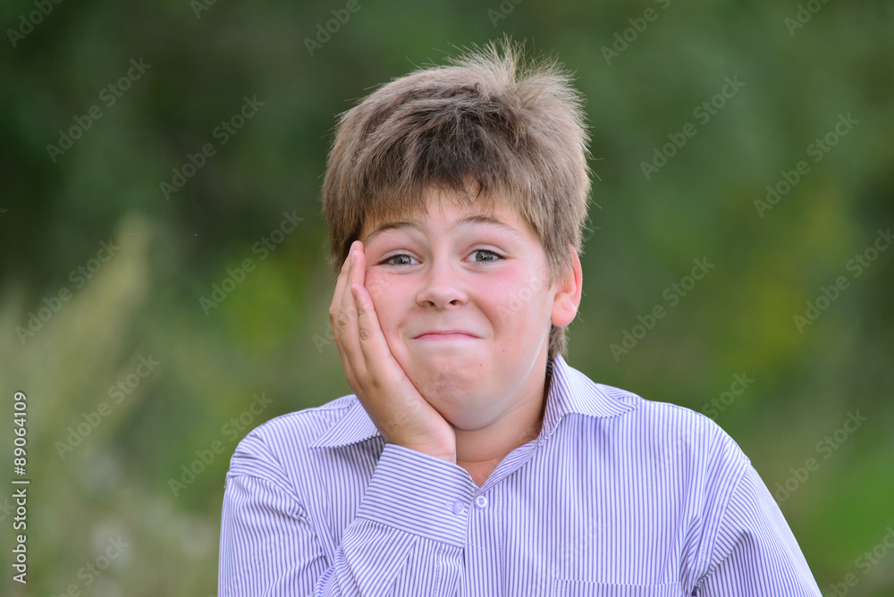 Astonished boy holding his hands behind head Astonished boy holding his hands behind head