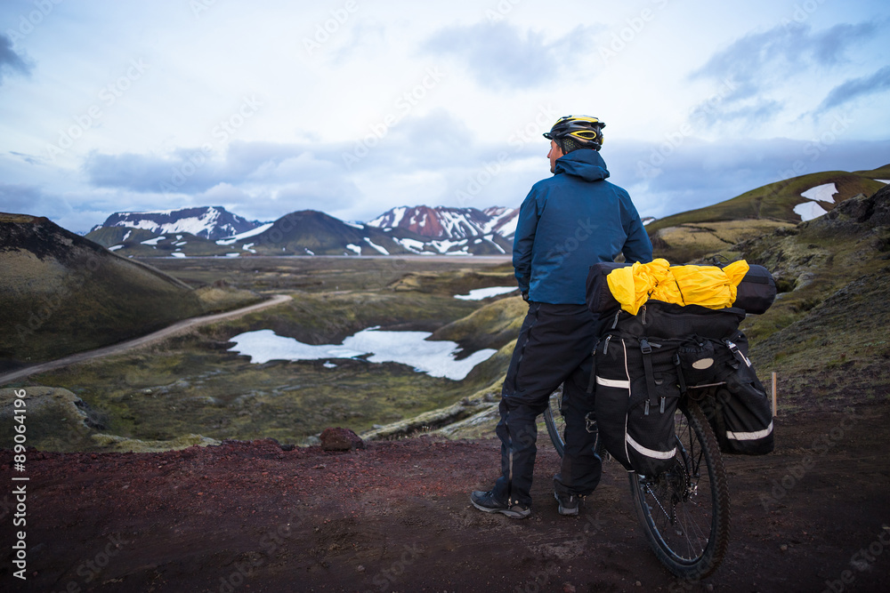 Fototapeta premium Happy biker on backdrop of volcanic mountains in Iceland