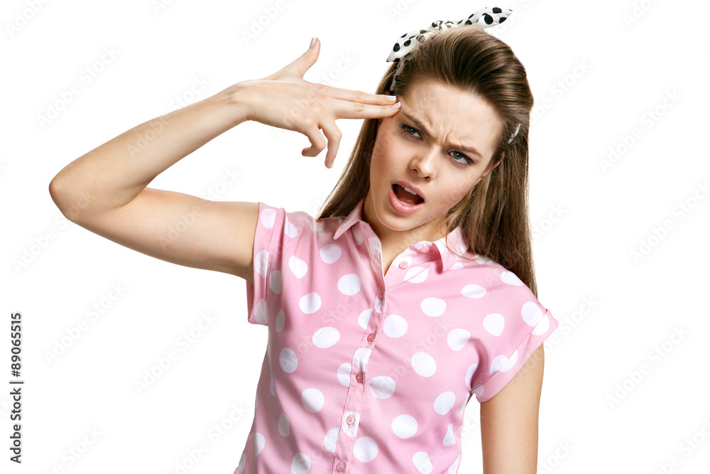 Head-shot portrait of girl committing suicide touching her temple with finger gun gesture. Head-shot portrait of girl committing suicide touching her temple with finger gun gesture.