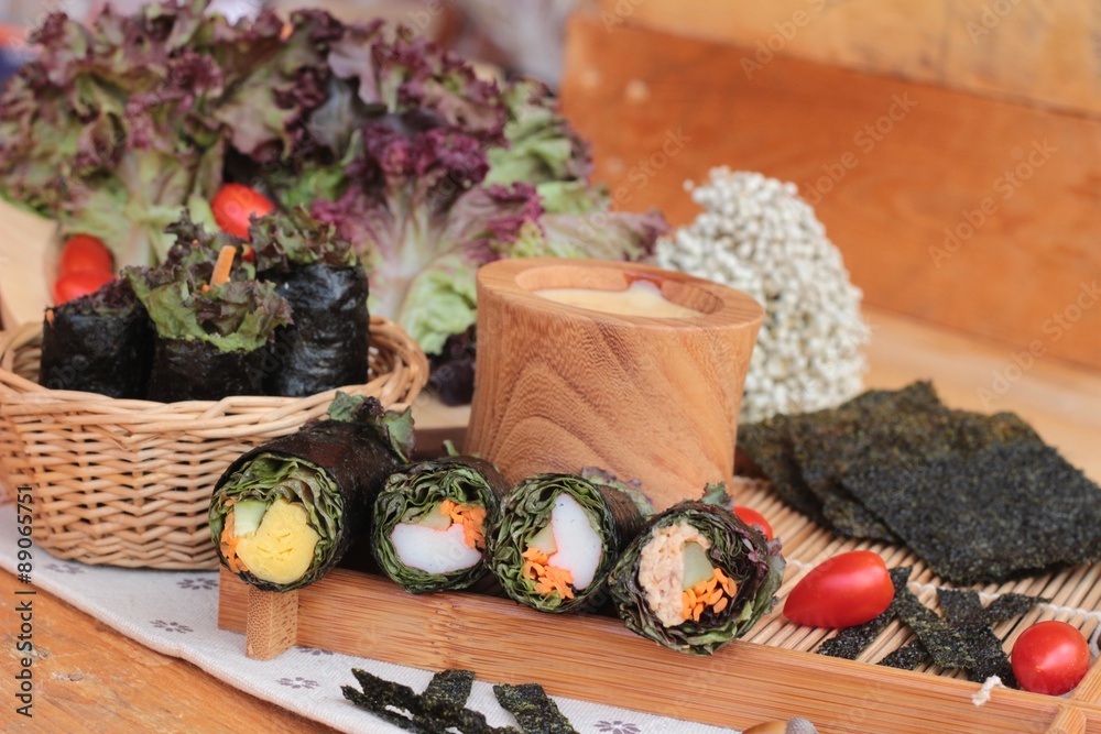 Vegetable salad wrapped with seaweed into spring rolls. Vegetable salad wrapped with seaweed into spring rolls.