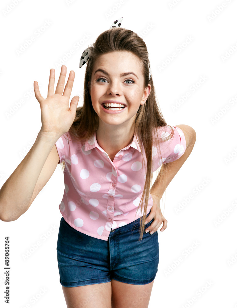 Smiling girl showing her hand up, greeting gesture Smiling girl showing her hand up, greeting gesture