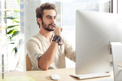 Young man working on computer photo