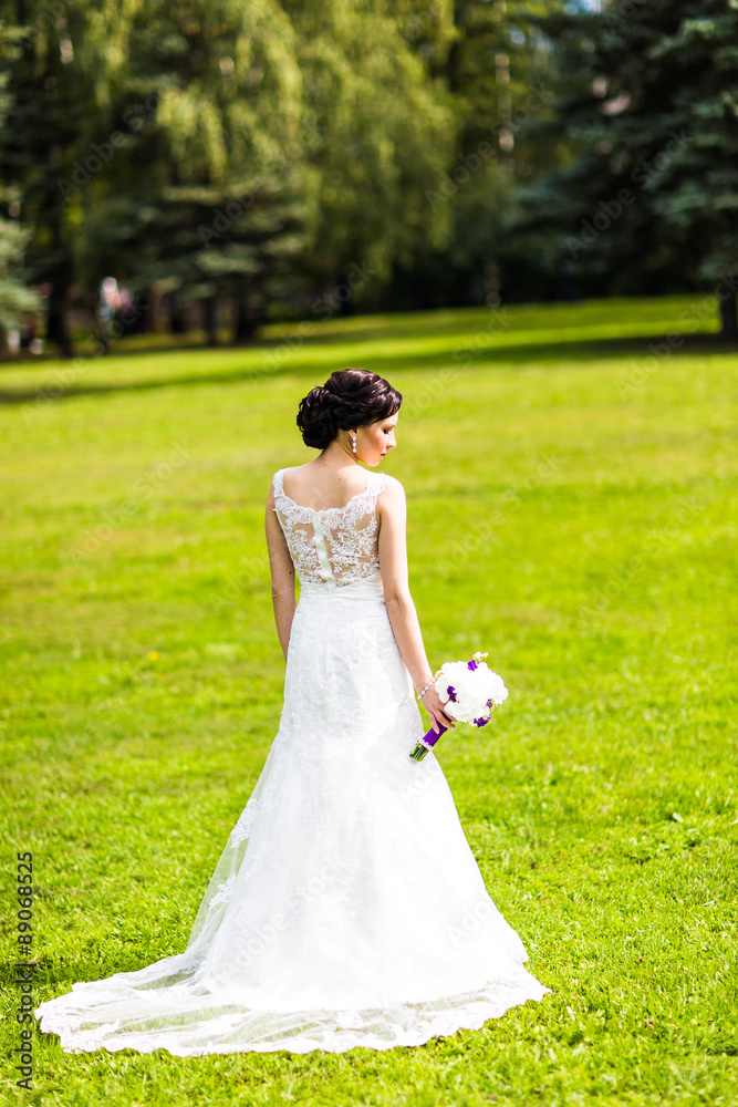 Beautiful bride in wedding dress and bridal bouquet